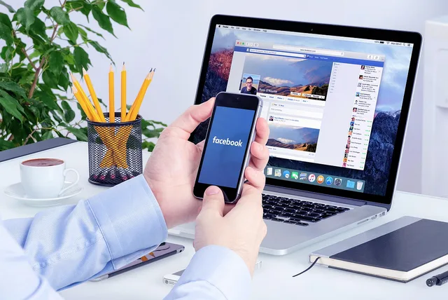 facebook, social media, social media marketing, smartphone, laptop, workspace, office break, office hour, desk, facebook marketing, facebook ads, facebook ads, facebook ads, facebook ads, facebook ads, facebook ads. Checking a paid social advert in England before it goes live