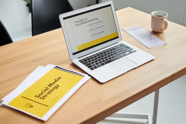 Close-up of a laptop showing a social media marketing strategy in an office setting. A gated paid social workflow for agencies in England: six stages from intake record to evidenced close